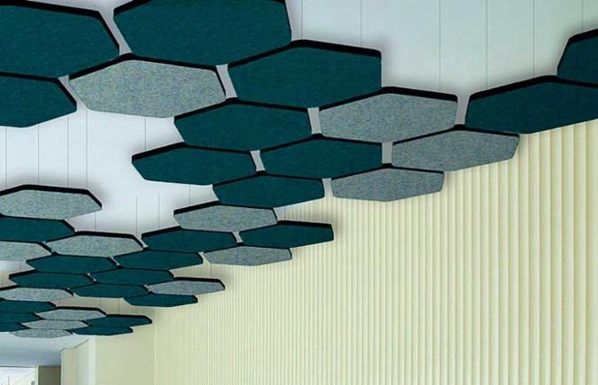 Hexagonal acoustic clouds suspended from a ceiling